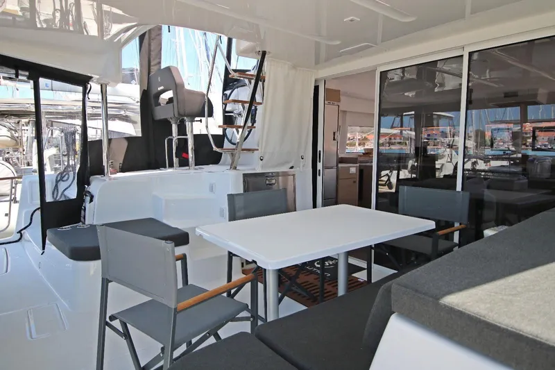 Yacht Photos Pics Spacious interior of 2025 Lagoon 43 yacht with modern seating and dining area.