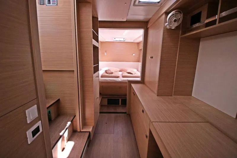  Yacht Photos Pics Luxurious interior of 2025 Lagoon 43 yacht with modern wood finish and cozy bedroom.