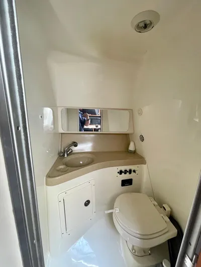  Yacht Photos Pics 2005 Hydra-Sports Vector 3300 VX boat bathroom with sink, mirror, and toilet.