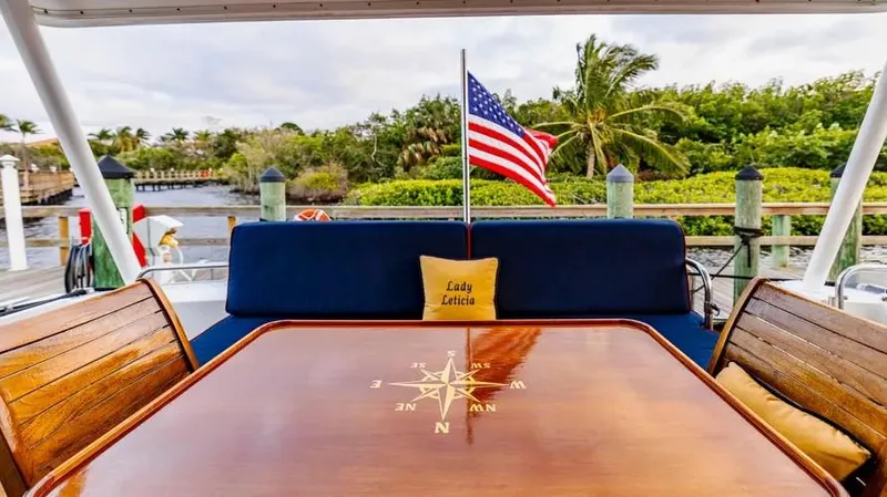  Yacht Photos Pics Luxurious 2000 Pacific Mariner 65 Motoryacht deck with compass table and American flag.