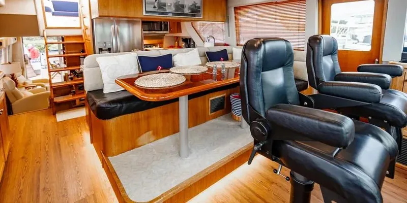  Yacht Photos Pics Luxurious interior of a 2000 Pacific Mariner 65 Motoryacht with leather seating and wooden accents.