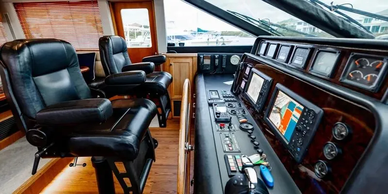  Yacht Photos Pics Interior helm of 2000 Pacific Mariner 65 Motoryacht with navigation equipment and leather seating.