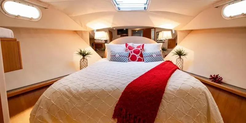  Yacht Photos Pics Luxurious bedroom interior of 2000 Pacific Mariner 65 Motoryacht with elegant decor and lighting.