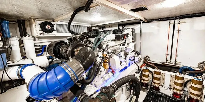  Yacht Photos Pics Engine room of 2000 Pacific Mariner 65 Motoryacht, showcasing complex machinery and piping.