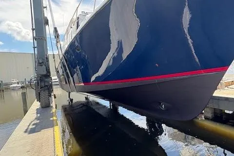  Yacht Photos Pics 2000 Pacific Mariner 65 Motoryacht being lifted from water at a marina.