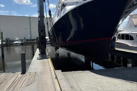  Yacht Photos Pics 2000 Pacific Mariner 65 Motoryacht being lifted at a marina dock.