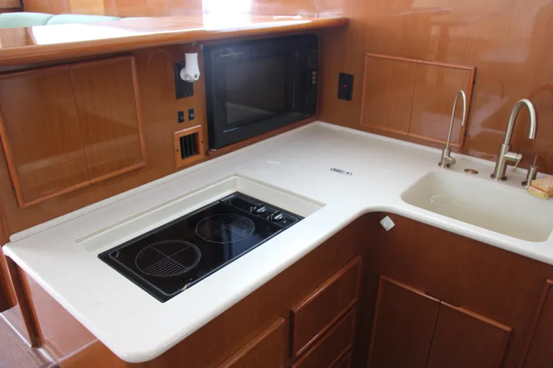 Galatea Yacht Photos Pics Modern yacht kitchen with stove, sink, and microwave, Post 50 model, year 2000.