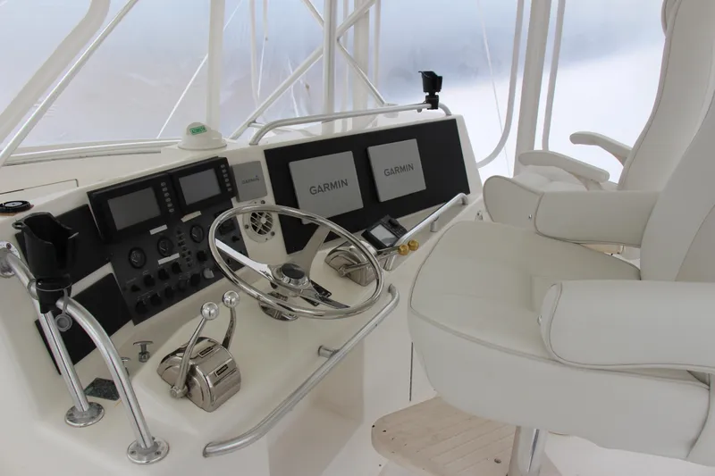 Galatea Yacht Photos Pics Helm of 2000 Post 50 yacht with Garmin navigation and white captain's chair.
