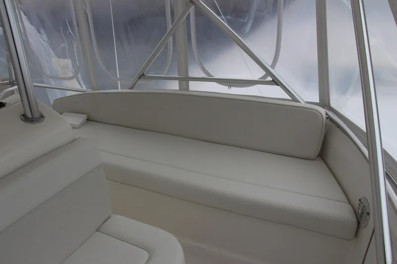 Galatea Yacht Photos Pics Interior of a 2000 Post 50 boat with white seating and clear windows.