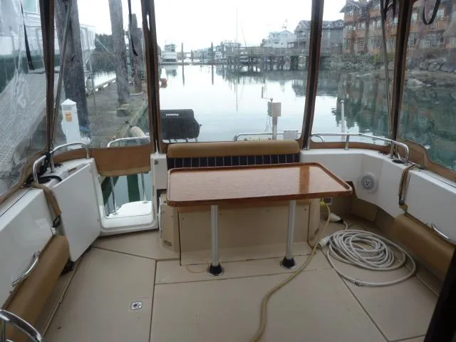 Island Wanderer Yacht Photos Pics 2013 Ranger Tugs R-31 boat interior with table, docked at marina.