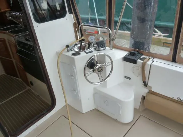 Island Wanderer Yacht Photos Pics 2013 Ranger Tugs R-31 helm station with steering wheel and navigation controls.