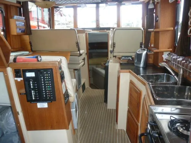 Island Wanderer Yacht Photos Pics Interior of 2013 Ranger Tugs R-31 boat with kitchen and seating area.