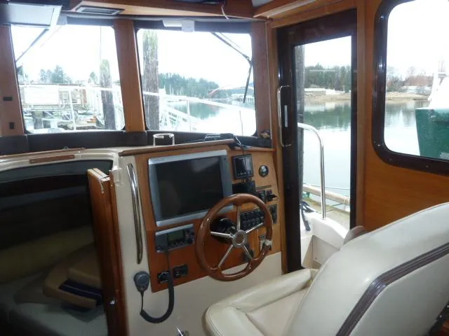 Island Wanderer Yacht Photos Pics Interior of 2013 Ranger Tugs R-31 boat with steering wheel and navigation equipment.
