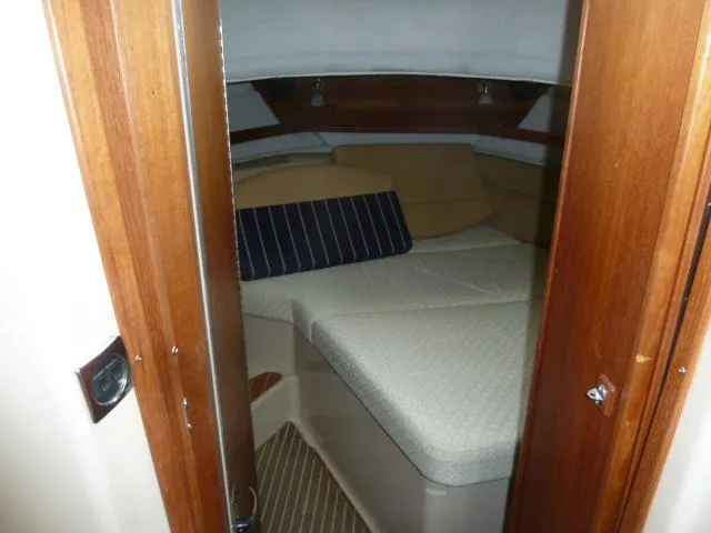 Island Wanderer Yacht Photos Pics 2013 Ranger Tugs R-31 cabin interior with cozy bed and wooden accents.