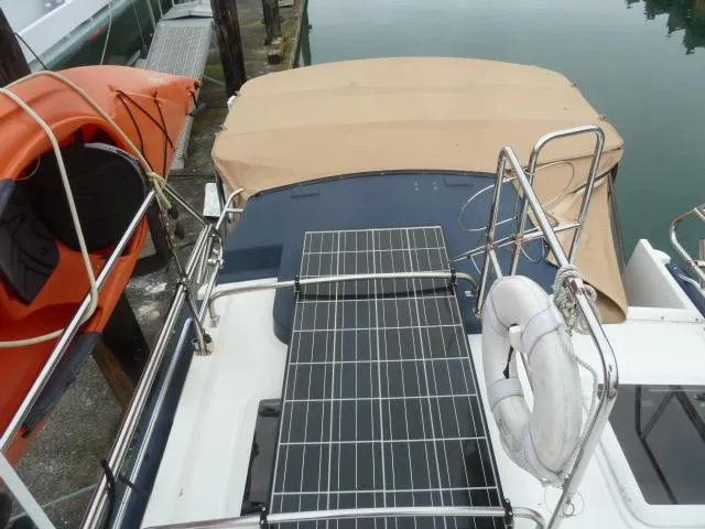 Island Wanderer Yacht Photos Pics 2013 Ranger Tugs R-31 boat with solar panels and beige canopy, docked near water.