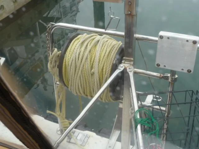 Island Wanderer Yacht Photos Pics Ranger Tugs R-31 (2013) boat with coiled rope on deck near water.