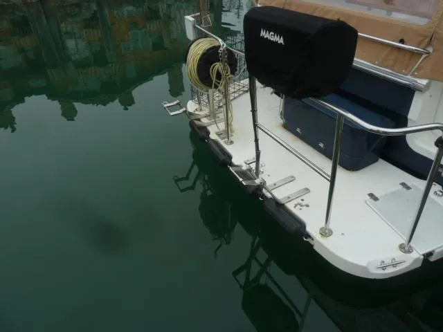 Island Wanderer Yacht Photos Pics 2013 Ranger Tugs R-31 boat stern with equipment and calm water reflection.