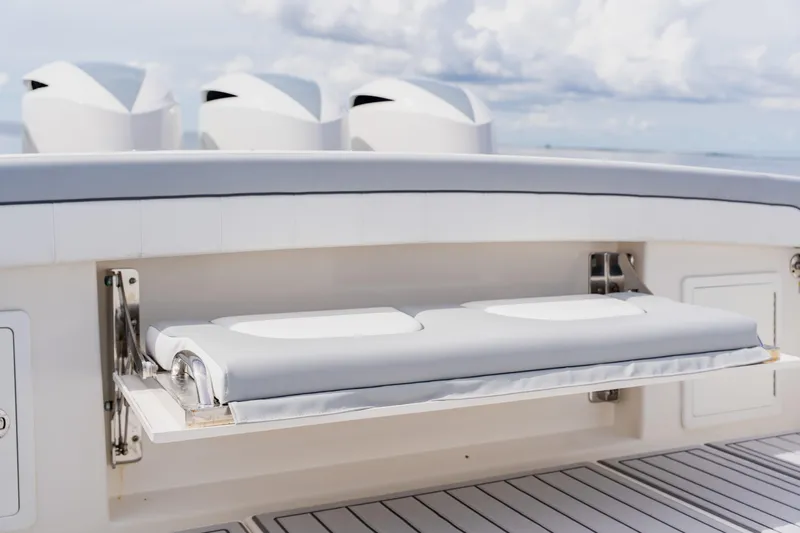  Yacht Photos Pics 2018 Regulator 41 boat with foldable cushioned seat and sleek design.