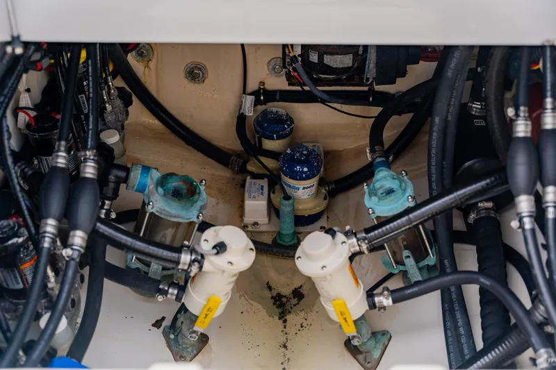  Yacht Photos Pics Engine compartment of a 2018 Regulator 41 boat, showcasing pumps and hoses.