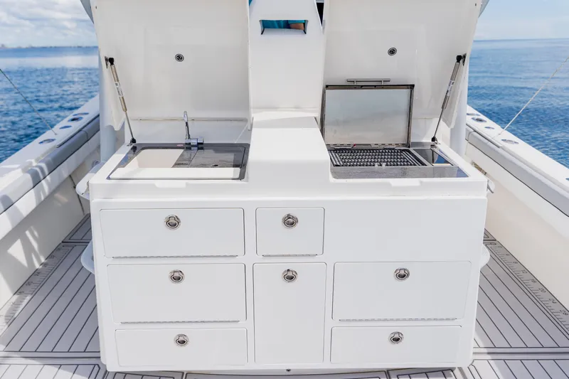 Yacht Photos Pics 2018 Regulator 41 boat with onboard sink and grill station, ocean backdrop.