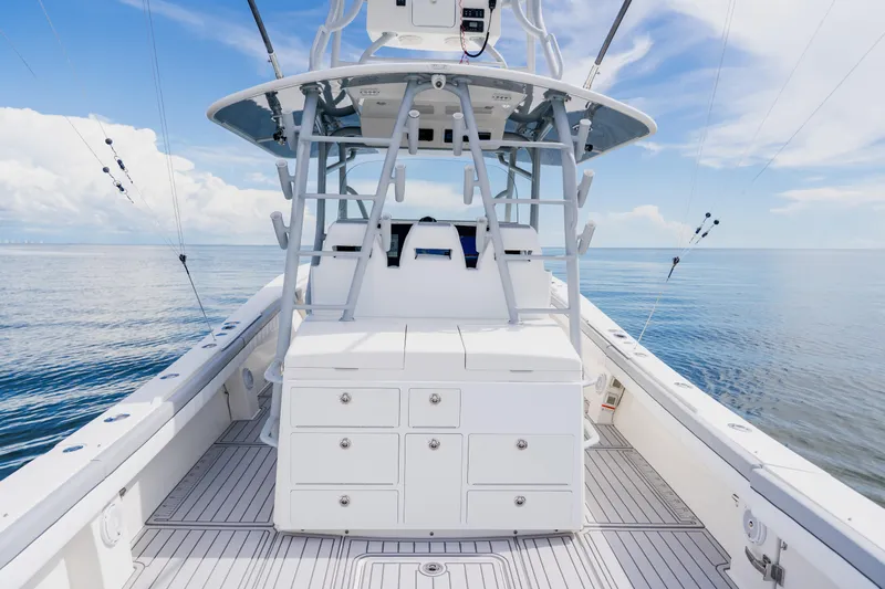  Yacht Photos Pics 2018 Regulator 41 boat interior with fishing equipment, calm ocean backdrop.