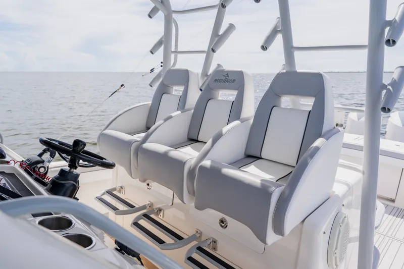  Yacht Photos Pics 2018 Regulator 41 boat interior with three cushioned seats and steering wheel.