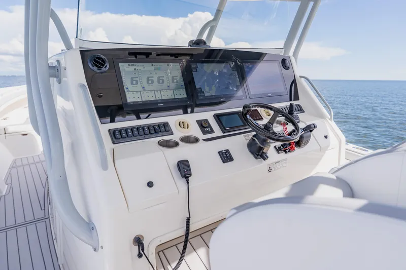  Yacht Photos Pics Control panel of a 2018 Regulator 41 boat with ocean view.