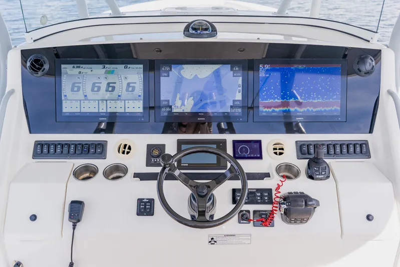  Yacht Photos Pics Control panel of a 2018 Regulator 41 boat with advanced navigation displays.
