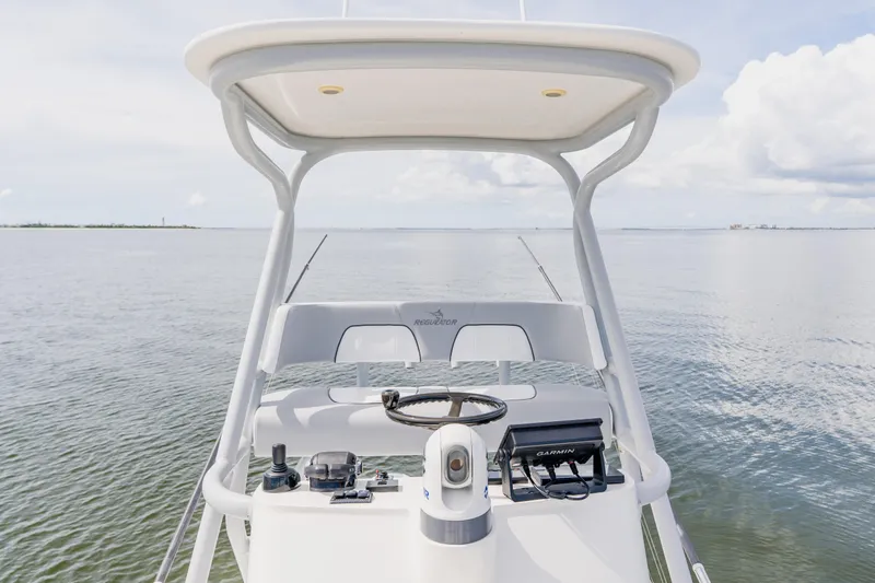  Yacht Photos Pics 2018 Regulator 41 boat helm with Garmin navigation, on calm waters under a cloudy sky.