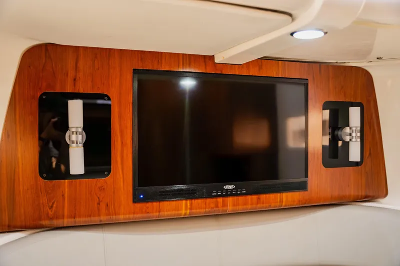  Yacht Photos Pics Entertainment system on 2018 Regulator 41 boat, featuring a wall-mounted TV and modern lighting.