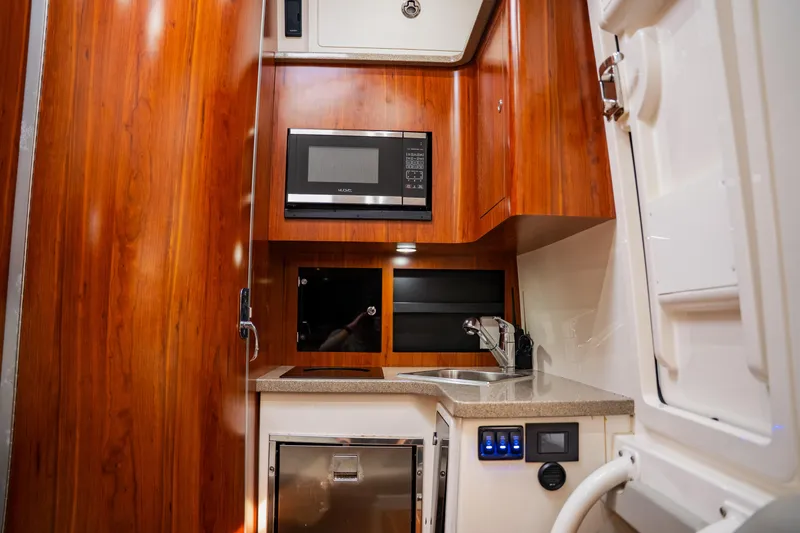  Yacht Photos Pics Luxurious 2018 Regulator 41 yacht interior with wood finish, kitchenette, and modern amenities.