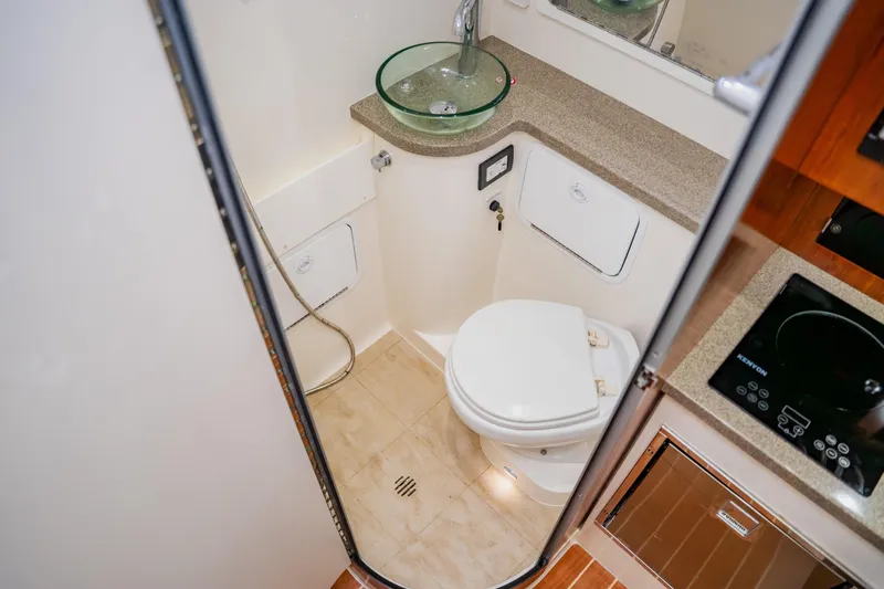  Yacht Photos Pics 2018 Regulator 41 boat bathroom with glass sink and modern amenities.