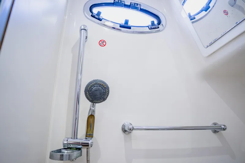  Yacht Photos Pics Shower area in 2018 Regulator 41 boat with chrome fixtures and porthole window.
