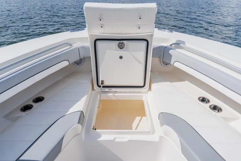  Yacht Photos Pics 2018 Regulator 41 boat interior with open storage compartment, white seating, and ocean backdrop.