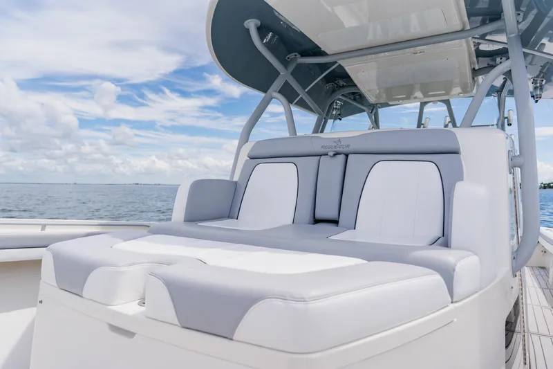  Yacht Photos Pics 2018 Regulator 41 boat with luxurious seating, ocean backdrop, and clear sky.