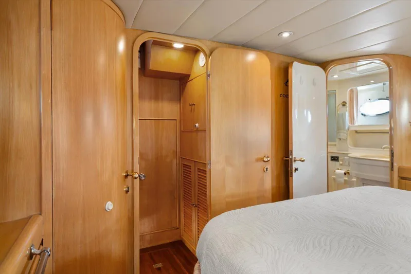  Yacht Photos Pics Luxurious 1996 Johnson High Tech Euro Motoryacht cabin with wooden interior and cozy bed.