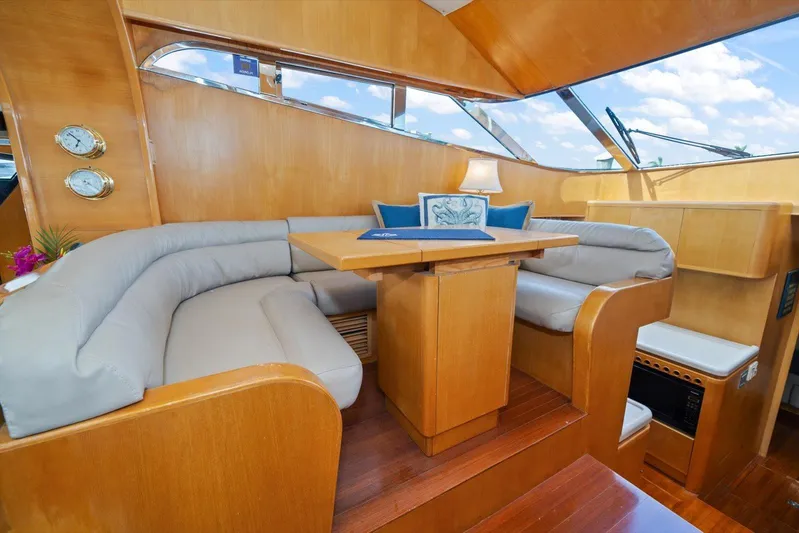  Yacht Photos Pics Luxurious 1996 Johnson High Tech Euro Motoryacht interior with plush seating and elegant wood finish.