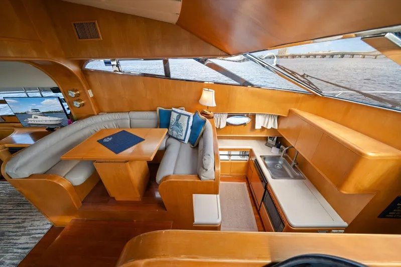  Yacht Photos Pics Luxurious 1996 Johnson High Tech Euro Motoryacht interior with elegant seating and kitchenette.