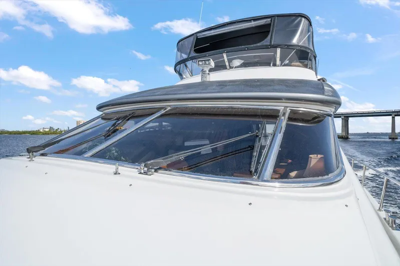  Yacht Photos Pics 1996 Johnson High Tech Euro Motoryacht on water, bridge in background, clear sky.