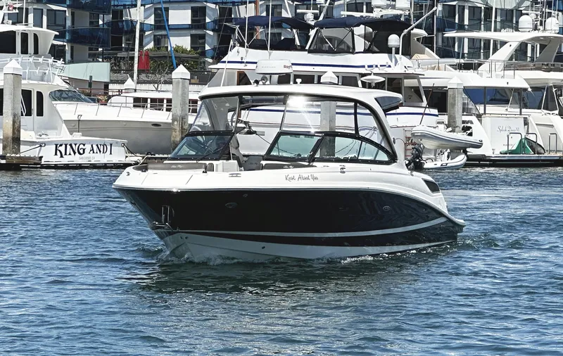 Knot About You Yacht Photos Pics 2017 Sea Ray SLX 350 boat cruising in a marina with yachts in the background.