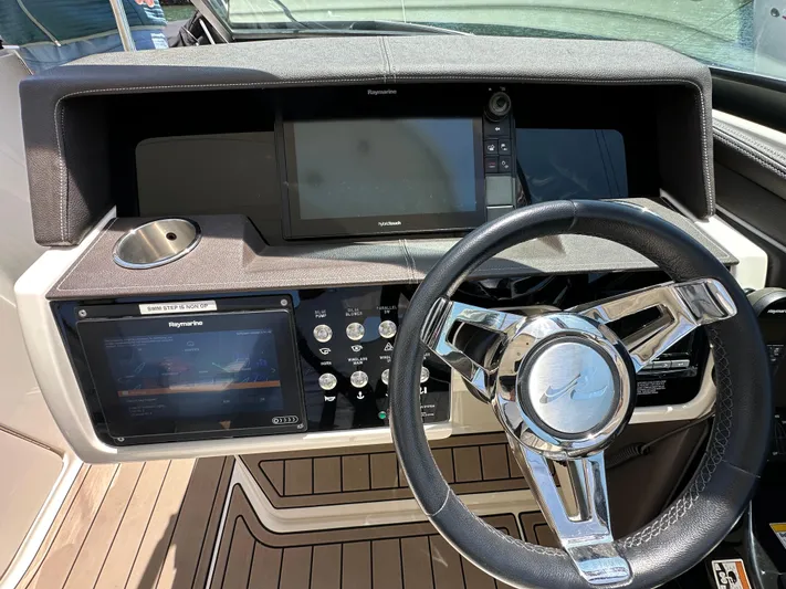 Knot About You Yacht Photos Pics 2017 Sea Ray SLX 350 helm with steering wheel, navigation screens, and control panel.