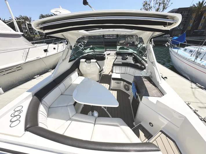 Knot About You Yacht Photos Pics 2017 Sea Ray SLX 350 boat interior with luxurious seating and table, docked at marina.