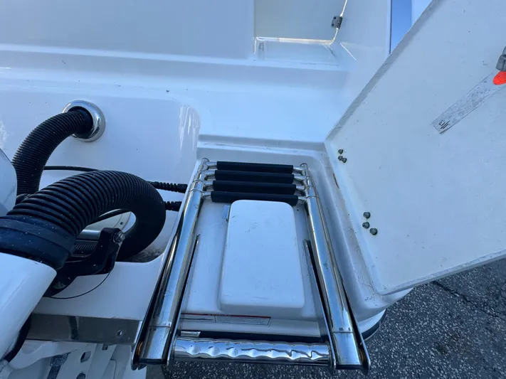  Yacht Photos Pics 2023 Robalo R270 Center Console boat ladder and storage compartment.