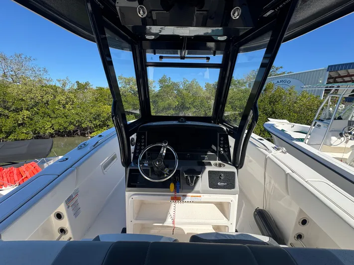  Yacht Photos Pics 2023 Robalo R270 Center Console boat interior with steering wheel and dashboard.