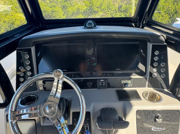  Yacht Photos Pics 2023 Robalo R270 Center Console dashboard with steering wheel and navigation screens.