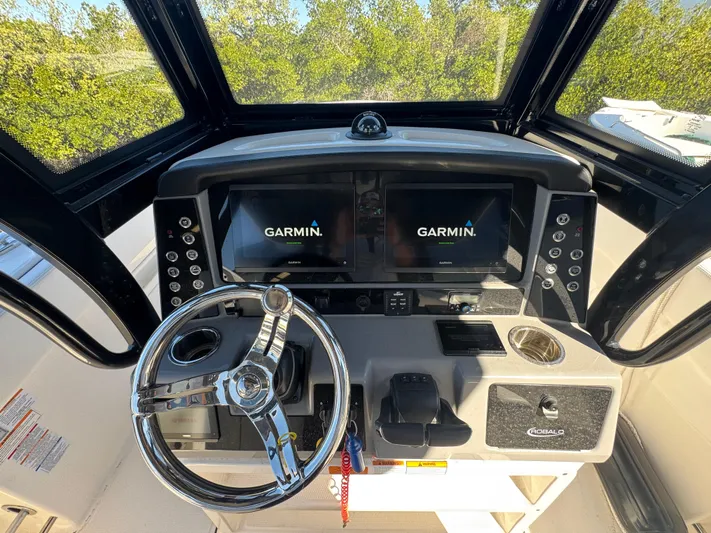  Yacht Photos Pics 2023 Robalo R270 Center Console helm with Garmin displays and steering wheel.