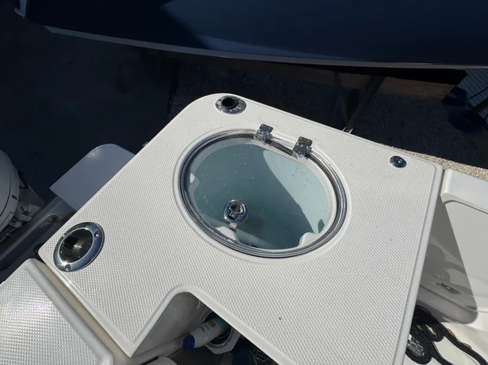  Yacht Photos Pics 2023 Robalo R270 Center Console livewell detail with textured surface.