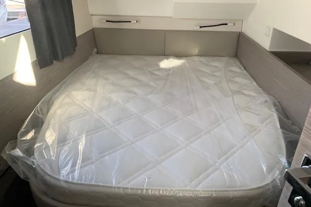 Cat&go Yacht Photos Pics 2025 Fountaine Pajot MY4.S cabin with a neatly wrapped mattress, modern interior design.