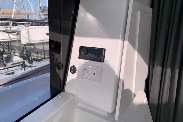 Cat&go Yacht Photos Pics Interior view of 2025 Fountaine Pajot MY4.S yacht, featuring control panel and window.
