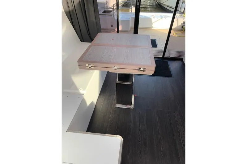 Cat&go Yacht Photos Pics 2025 Fountaine Pajot MY4.S yacht interior with a foldable wooden table and sleek flooring.